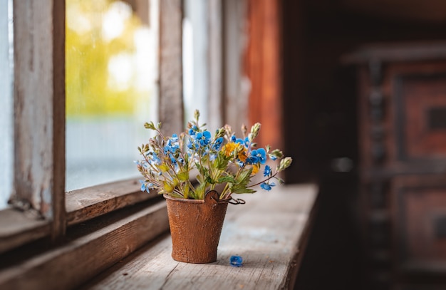 Mini bouquet of wildflowers in a decorative bucket