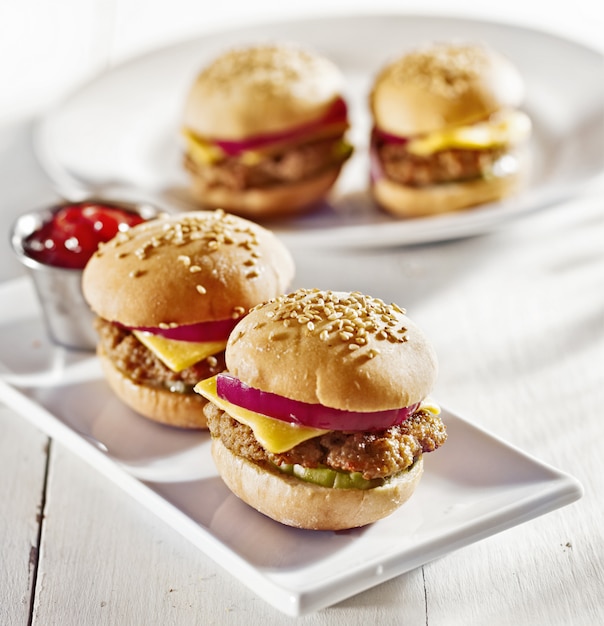 Mini burgers with cheese, onion and pickle