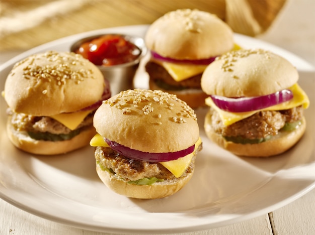 Mini burgers with cheese, onion and pickle