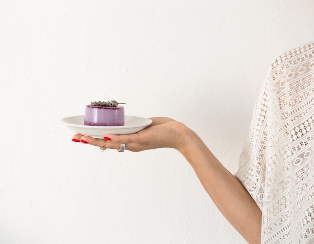 Mini cake or cheesecake in woman hands Dessert for Valentines Day