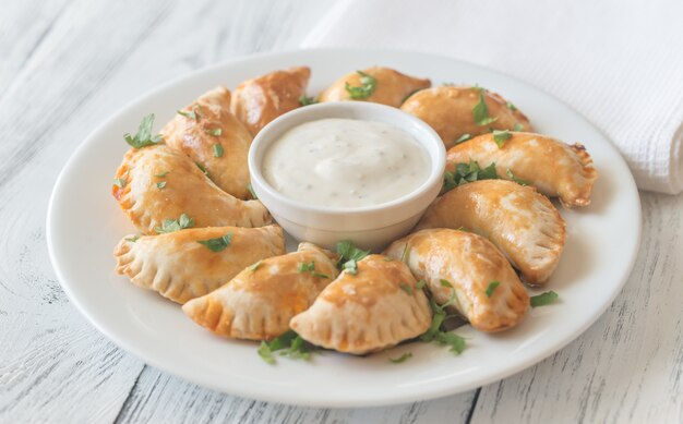 Mini chicken pies with creamy garlic sauce