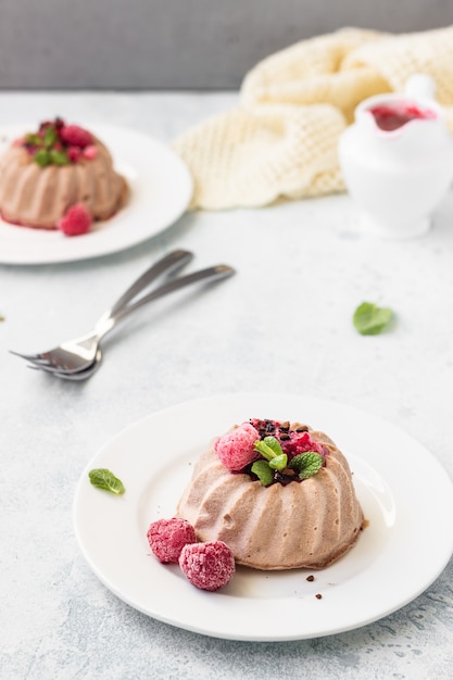 Mini chocolate no crust cheesecake with raspberry sauce and mint. Diet dessert. 