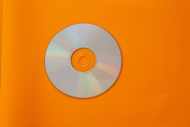 Mini compact disc isolated against orange background