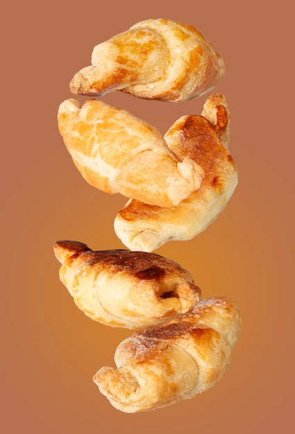 Mini croissants fly on a white background