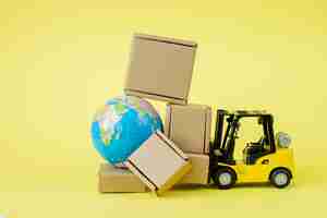 Photo mini forklift truck load cardboard boxes. fast delivery of goods and products. logistics, connection to hard-to-reach places. banner, copy space.