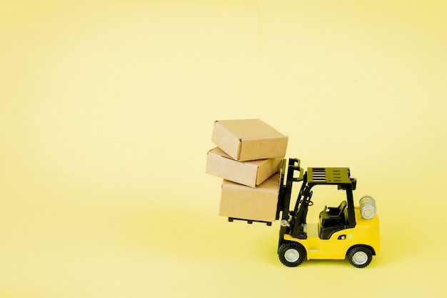 Mini forklift truck load cardboard boxes. Logistics and transportation management ideas and Industry business commercial concept.