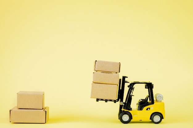 Mini forklift truck loading cardboard boxes