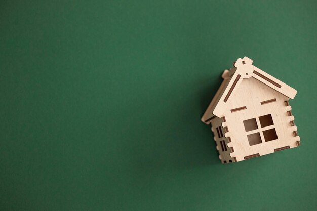Mini houten huis op groene achtergrond Residence en huis lening Concept