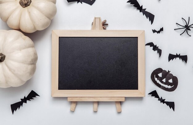 Mini leeg krijtbord met kopie ruimte en halloween decor op witte achtergrond Trick or treat Flat lay