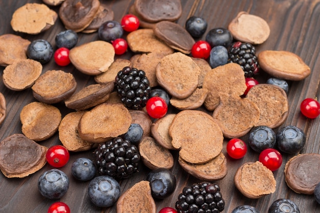 Mini pancakes and berries on a wooden table