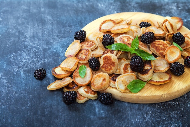 Mini pancakes, blackberries and mint leaves