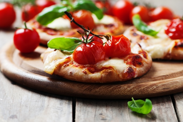 Mini pizza with mozzarella and tomato