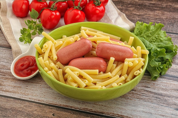 Mini sausages with pasta macheroni served tomato sauce