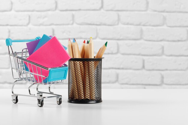 Mini shopping cart with multi-colored pens and pencils