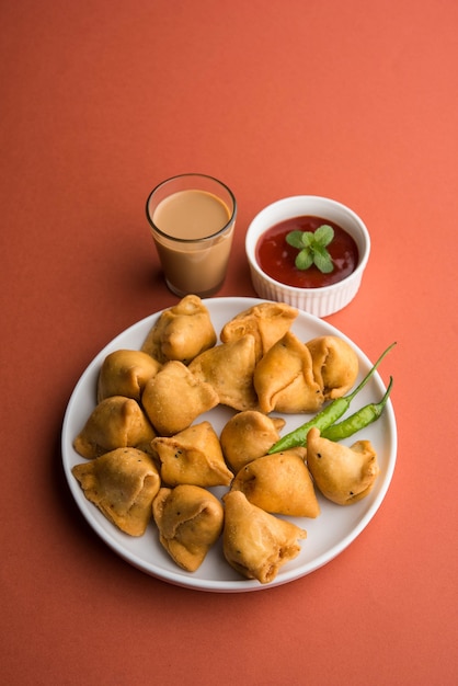 mini or small samosa with sauce and hot tea