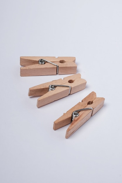 Mini spring clothespins on white background