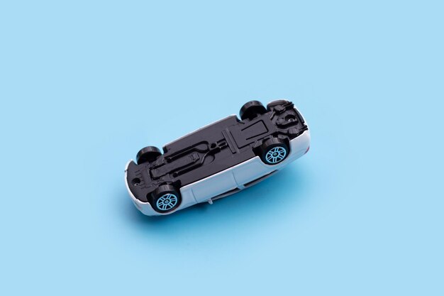 Mini toy car accident on blue background