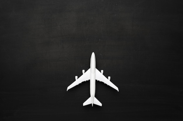 Miniature airplane on black background