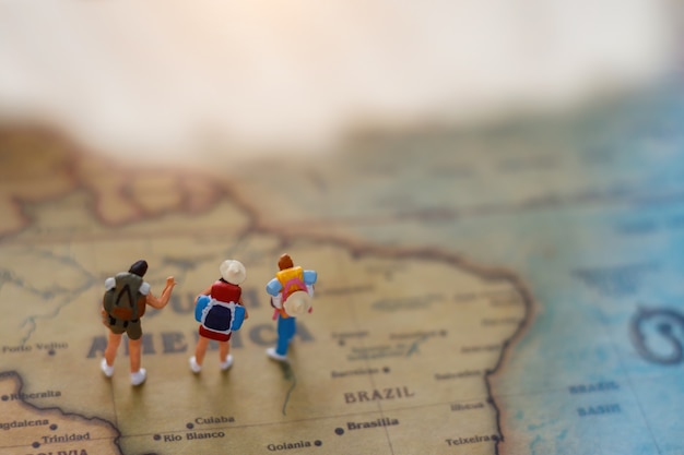 Miniature backpacker on map, Concept of Travel around the world and the adventure.