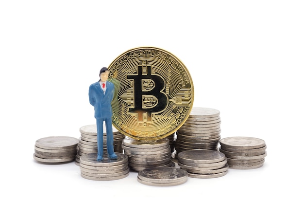 Miniature businessman and Bitcoin on white background