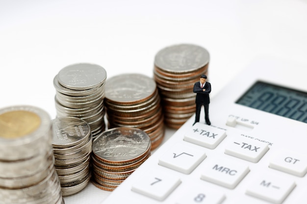 Miniature businessman on a calculator