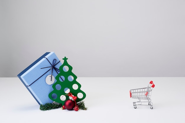 Miniature Christmas tree with gifts and a shopping cart