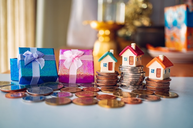 Miniature colorful house on stack coins using as property and financial concept