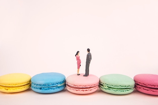 miniature couple on bridge made of macaroons