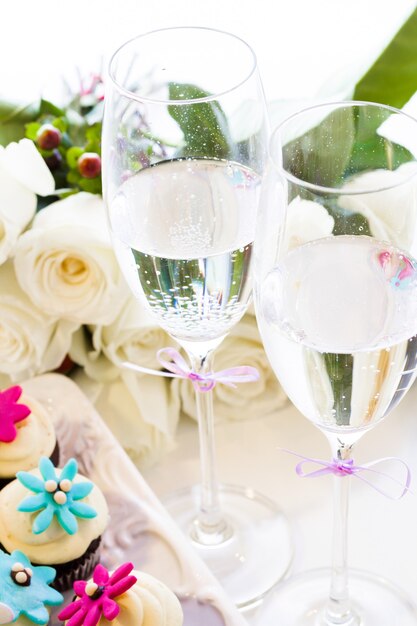 Miniature cupcakes decorated with bright flowers for the wedding party.