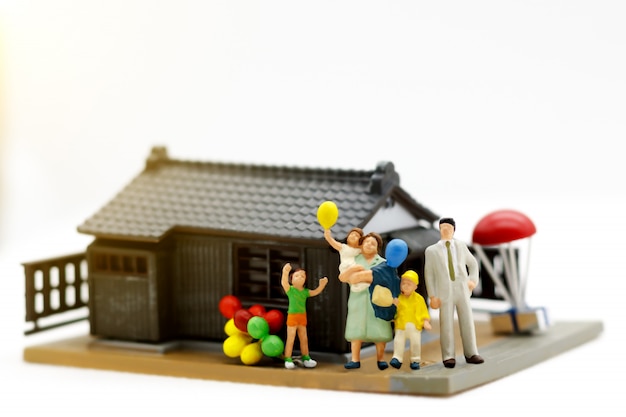 Miniature family in front of the house