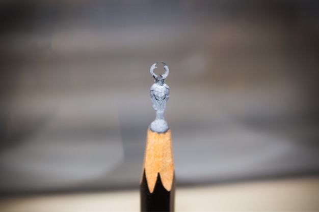 Miniature figurine of deer beetle carved at top of pencil lead. Titiqaqa Museum - Saint Petersburg