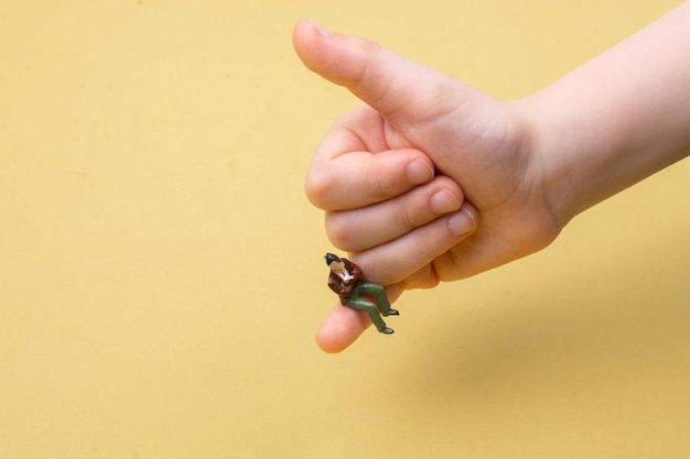 Miniature figurines of a man sitting in the palm of a hand