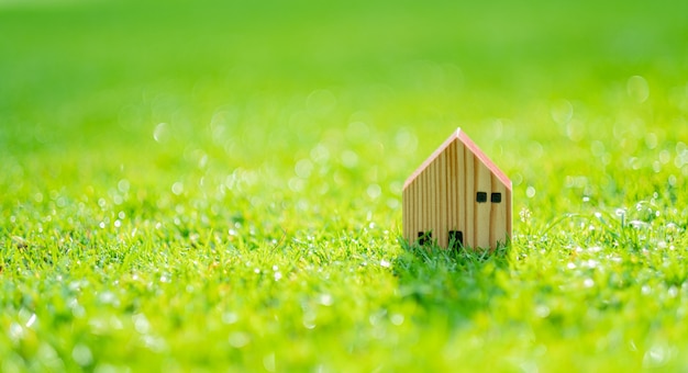 miniature house model on grass background