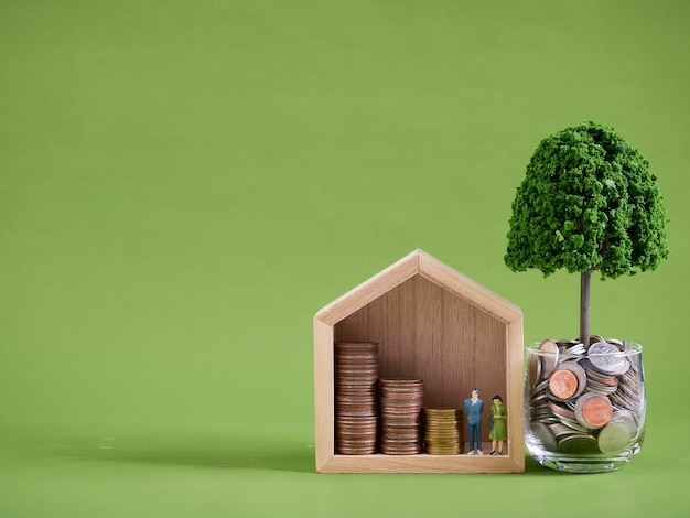 Miniature house model with coins stacks