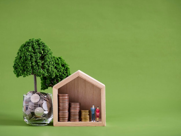 Miniature house model with coins stacks