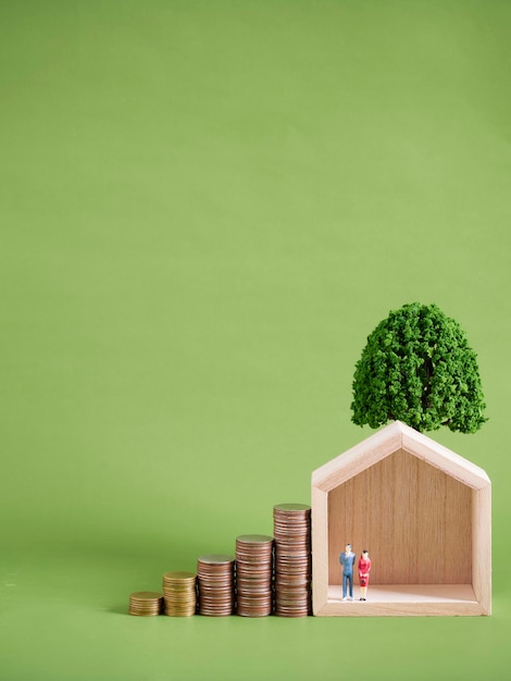 Miniature house model with coins stacks