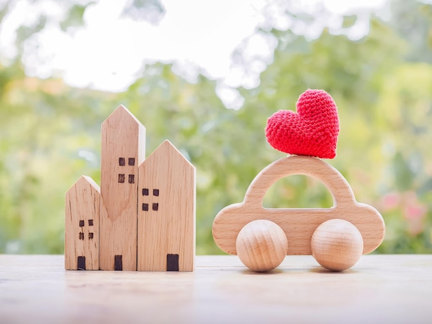 Miniature house Red heart and wooden toy car Concept of family