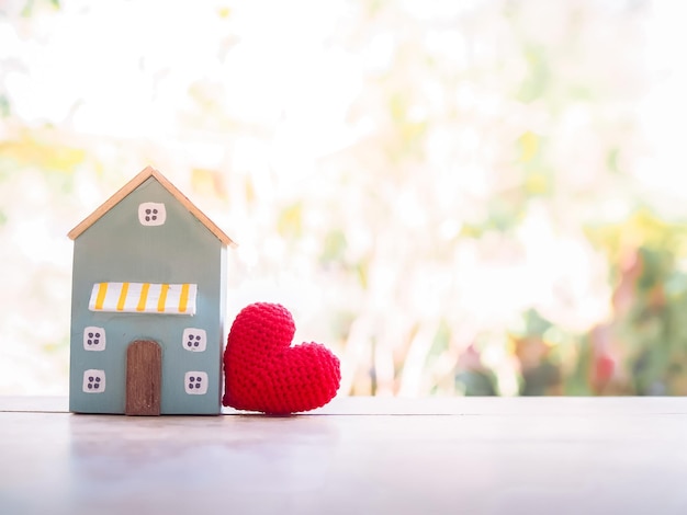 Miniature house with red heart for investment property concept