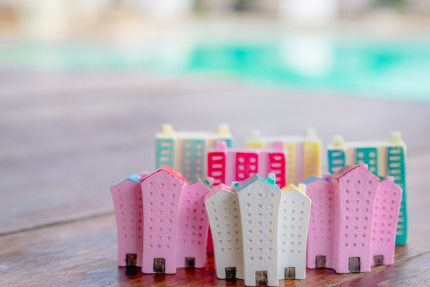 Miniature house on wooden background.