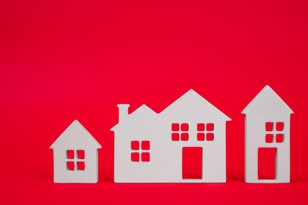 Miniature houses on red background