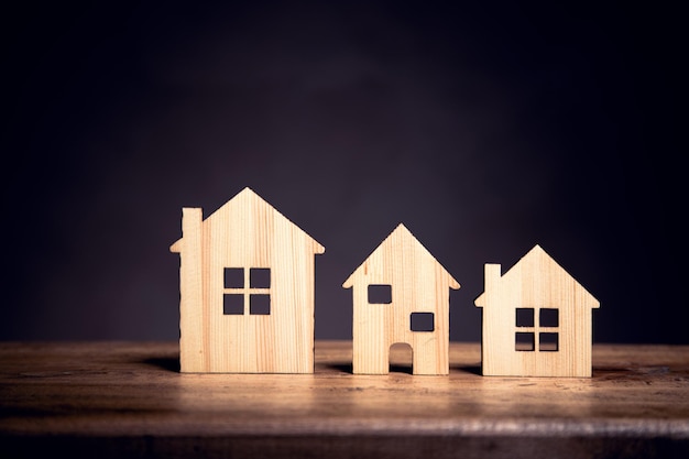 Miniature houses on wooden background