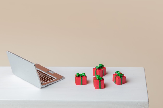 Miniature laptop and gift boxes on a table