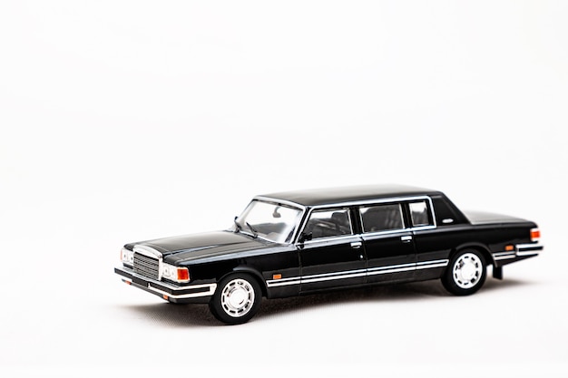 Miniature model of a retro car on a white surface