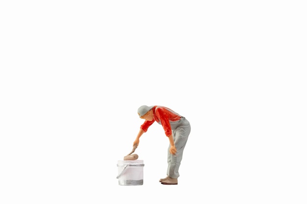 Miniature painter holding paint roller isolated on white background with clipping path