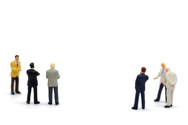 Miniature people: Business standing with team.