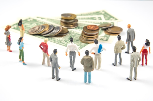 Photo miniature people businessman stands near dollar money investments and earnings for work