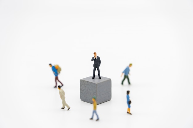 Miniature people businessmen standing on white Jigsaw.