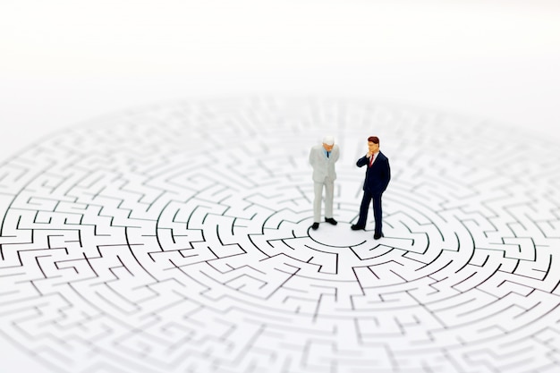 Miniature people in the center of a maze