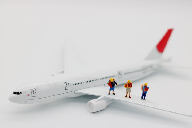 Miniature people: Children on airplane, travel concept.