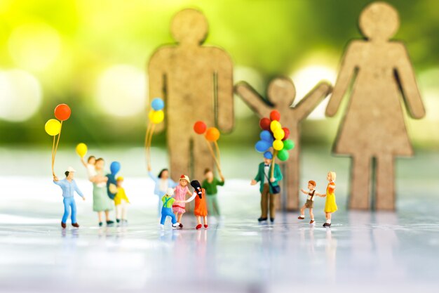 Miniature people: Children playing with ballon.